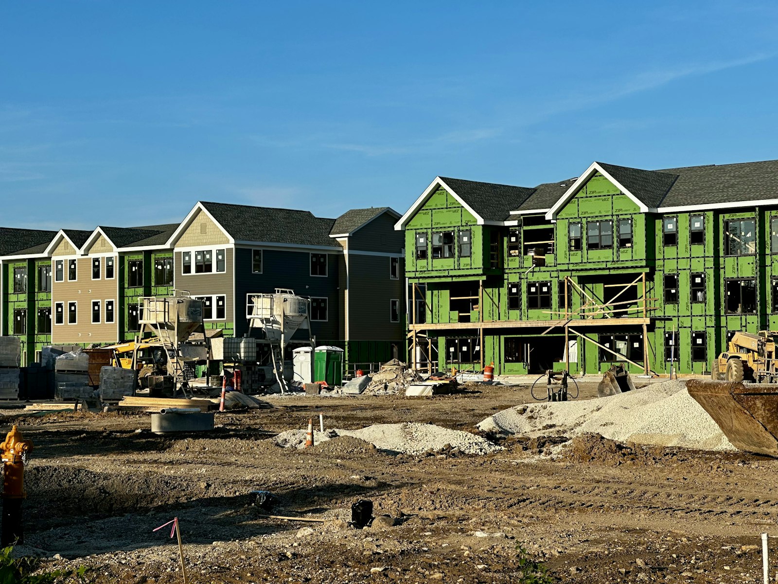 A row of houses under construction in a residential area