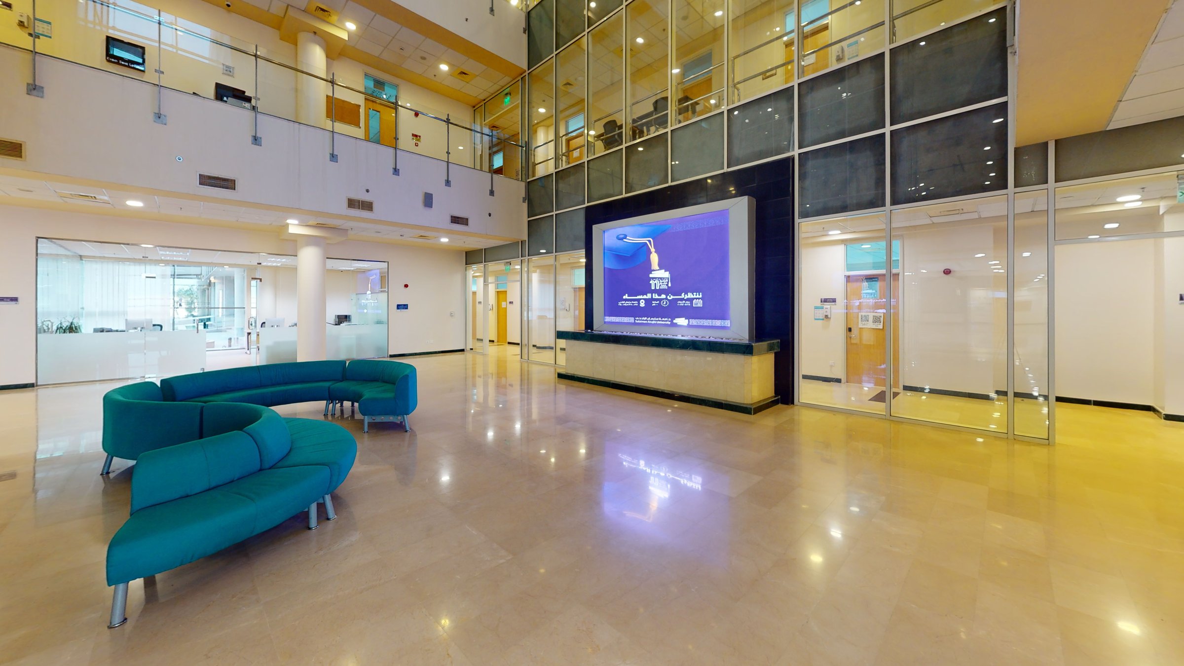 Double-height atrium lounge and information screen at Sulaiman Al Rajhi University