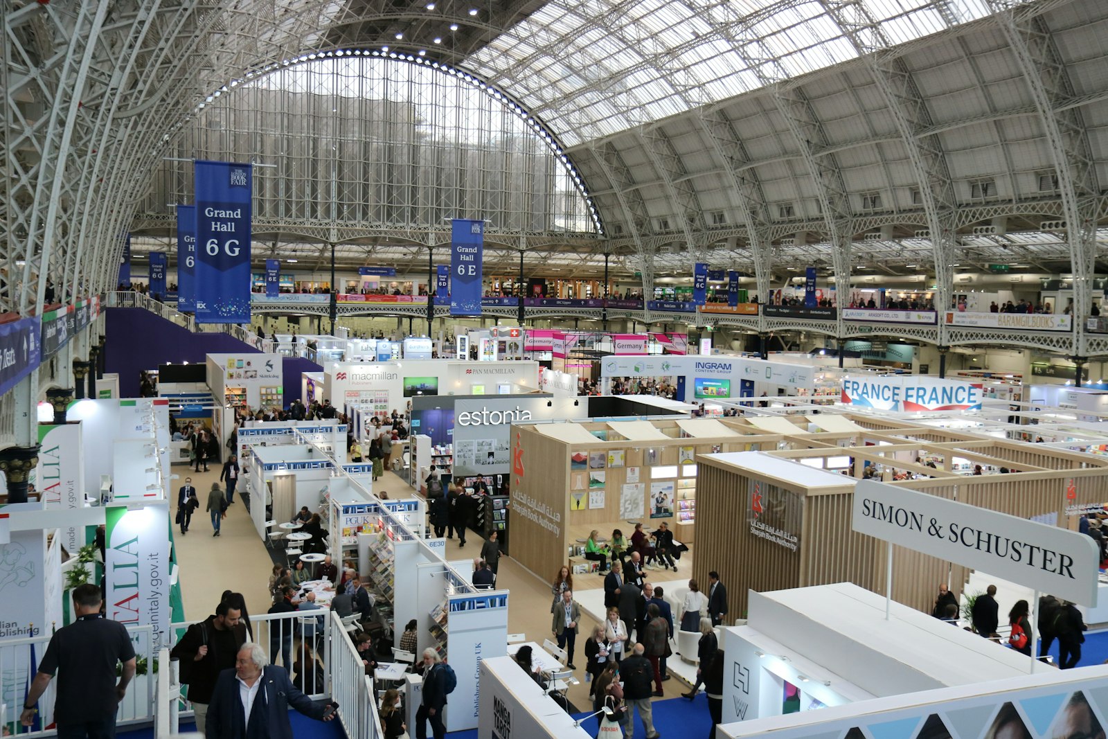 A busy exhibition hall with many booths and attendees